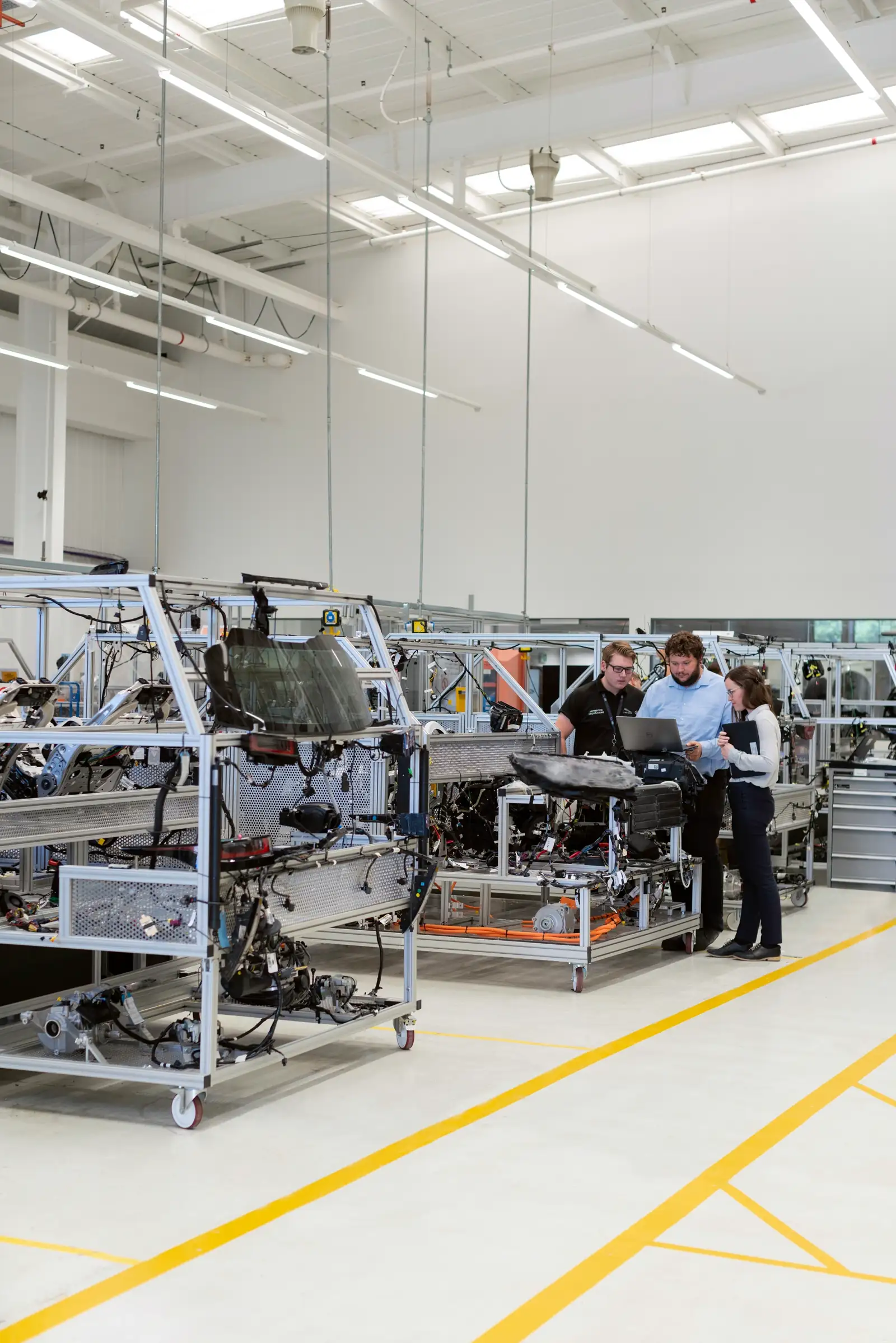 Business professionals reviewing production specifications in a modern manufacturing facility